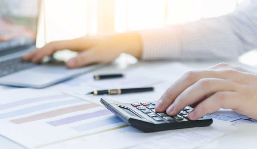 accounting records bvi OMC Group people with calculator image